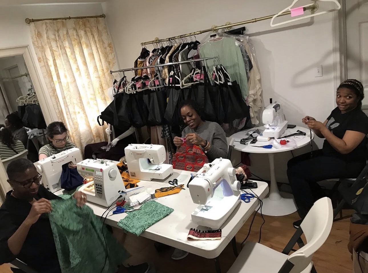 Customly Yours sewing class — students working at sewing machines together in a warm group setting