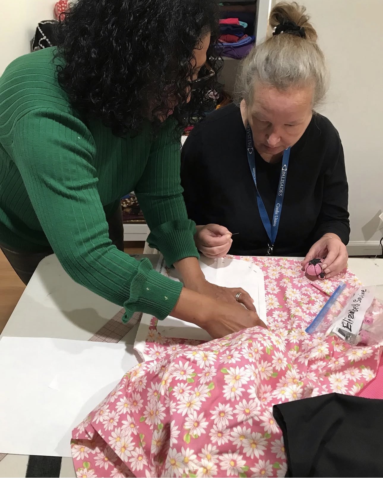 Lorraine pinning fabric and demonstrating pattern placement with a student