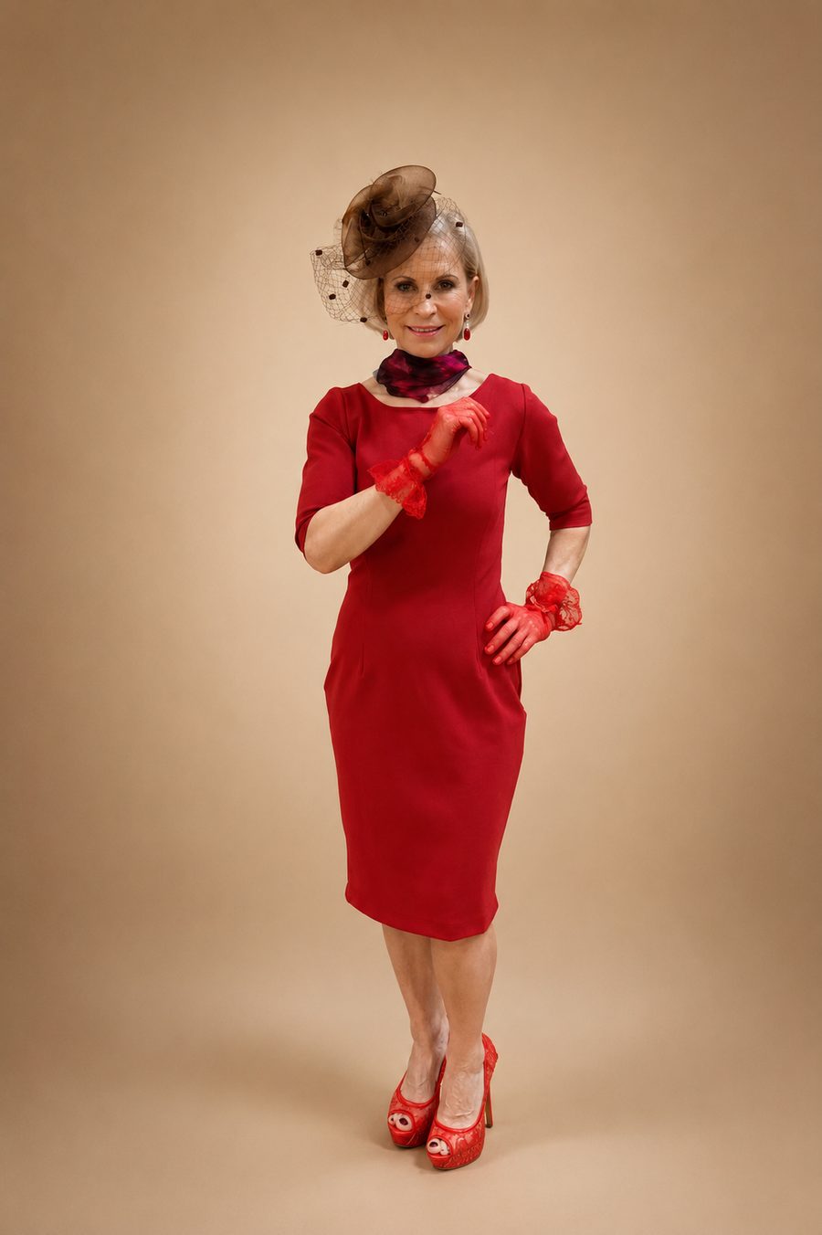 Custom red sheath dress styled with fascinator by Customly Yours Fashion